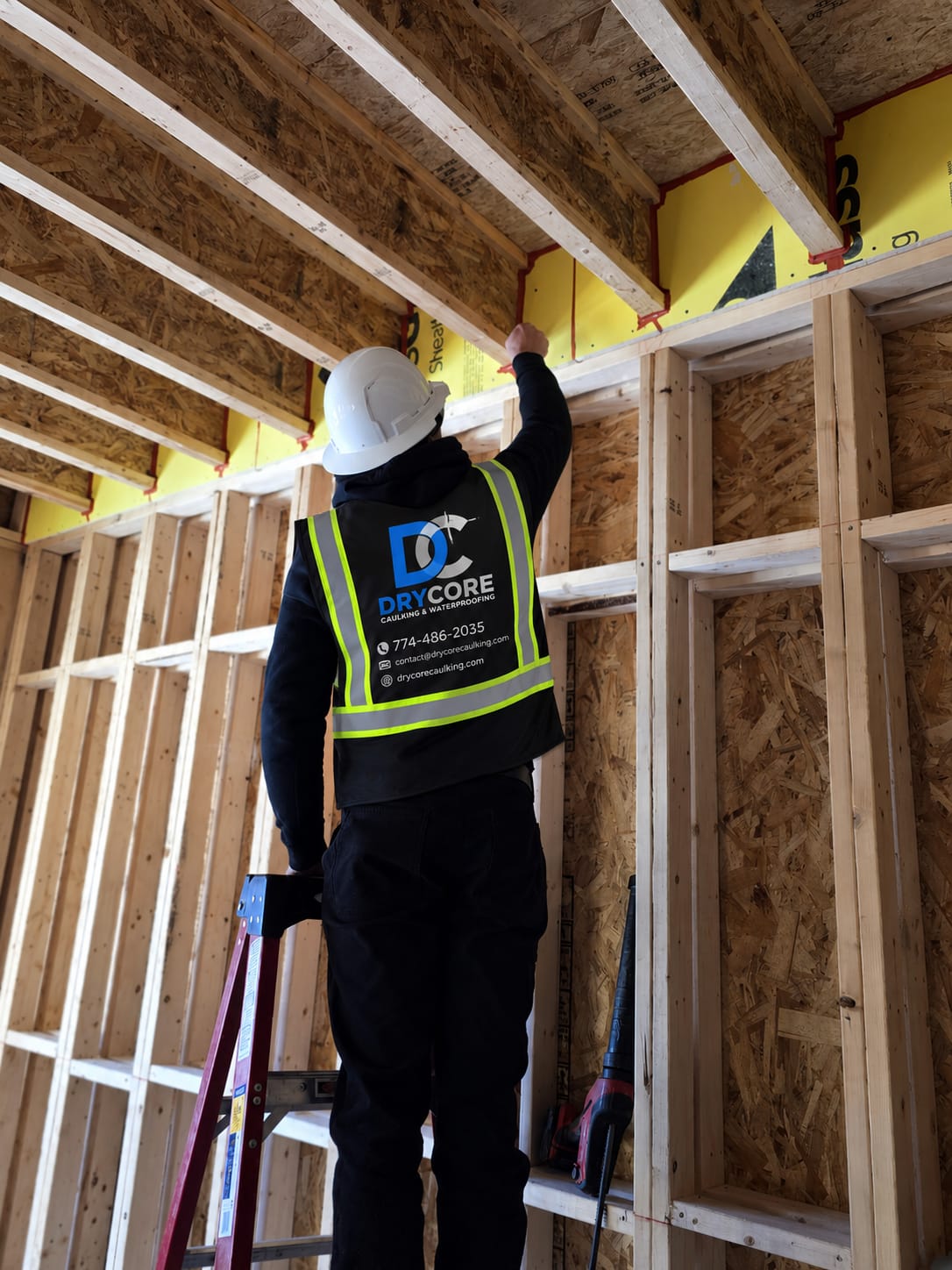 DryCore technician in a branded safety vest inspecting a job site
